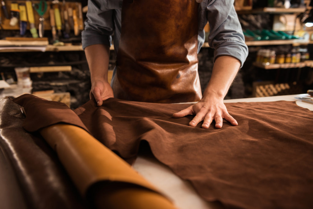 close up cobbler working with leather textile سيرة مدينة: الدريهمي من التَّهميش إلى واجهةِ الأحداث